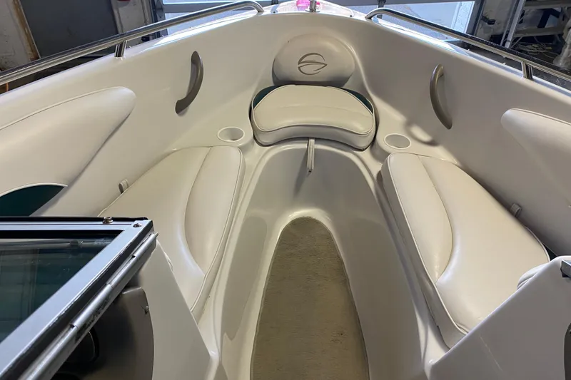 Slide: The Image of 2004 Crownline 192 BR boat interior with white seating and cup holders. - 14