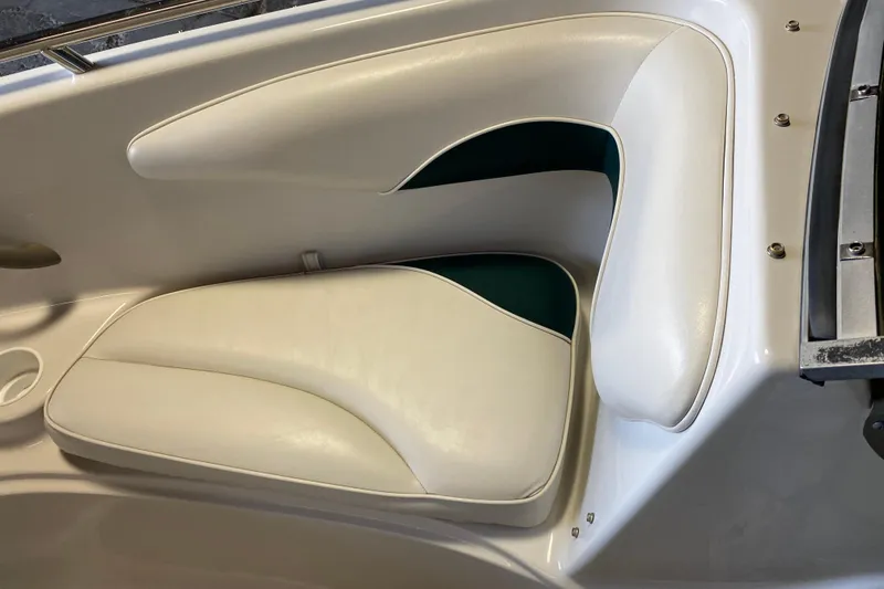 Slide: The Image of 2004 Crownline 192 BR boat interior with white cushioned seating. - 15