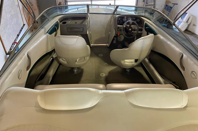 Slide: The Image of 2004 Crownline 192 BR boat interior with white seating and steering wheel. - 7