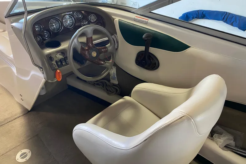 Slide: The Image of 2004 Crownline 192 BR boat interior with steering wheel and dashboard controls. - 9