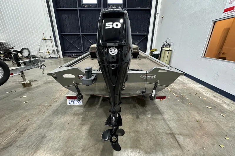 Slide: The Image of 2004 Bass Tracker 175 boat with Mercury 50 HP engine in a garage setting. - 2