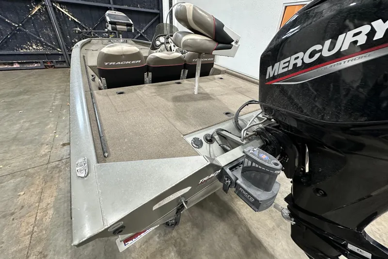 Slide: The Image of 2004 Bass Tracker 175 boat with Mercury engine in a garage setting. - 3