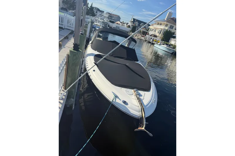Slide: The Image of 2005 Sea Ray 290 SLX boat docked at marina, covered and secured. - 2