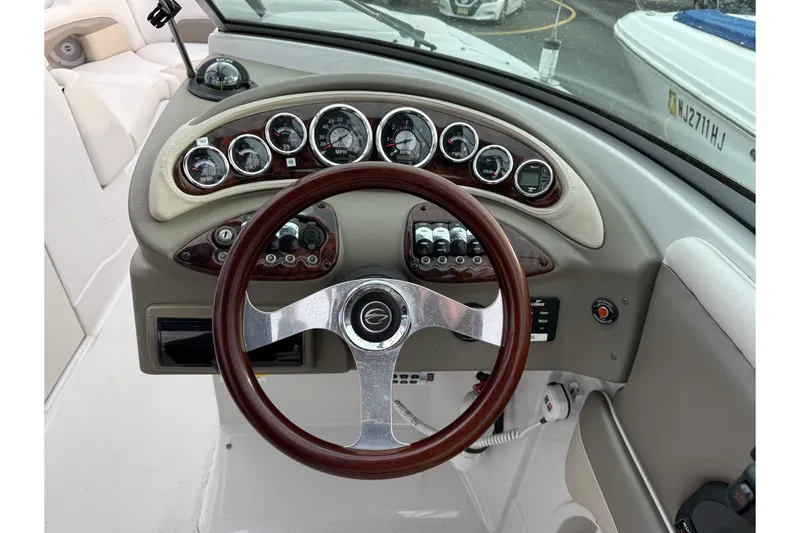 Slide: The Image of 2013 Crownline Eclipse E6 dashboard with gauges and wooden steering wheel. - 11