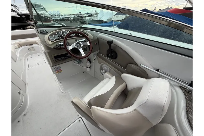 Slide: The Image of 2013 Crownline Eclipse E6 boat interior with steering wheel and dashboard controls. - 12