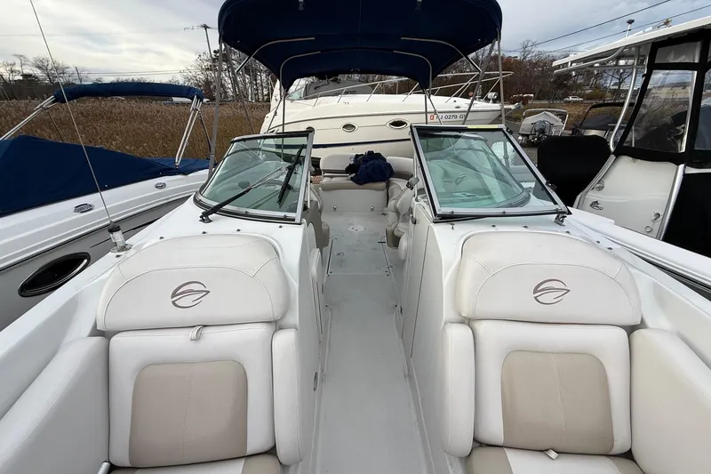 Slide: The Image of 2013 Crownline Eclipse E6 boat interior with white seating and blue canopy. - 18