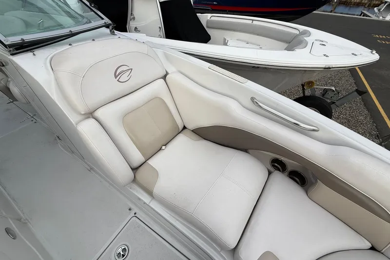 Slide: The Image of 2013 Crownline Eclipse E6 boat interior with white cushioned seating and cup holders. - 19