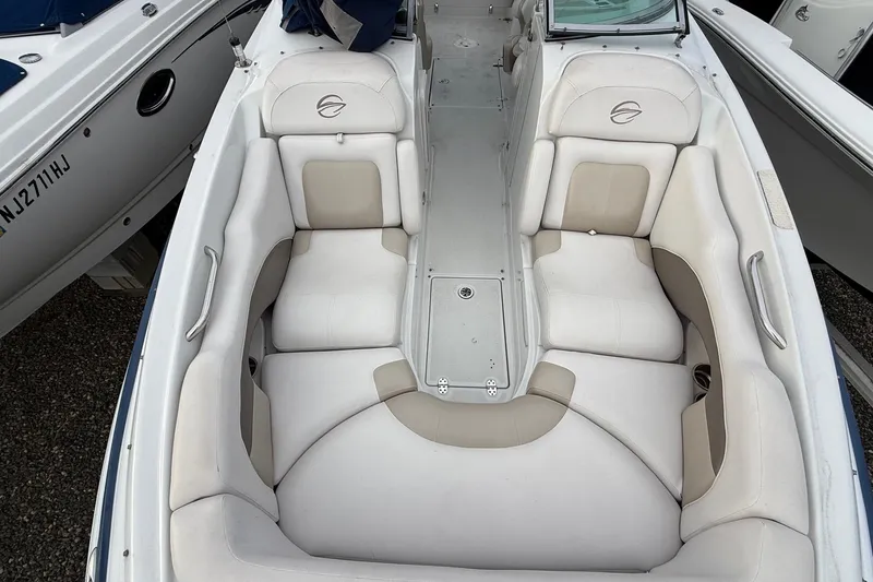 Slide: The Image of 2013 Crownline Eclipse E6 boat interior with white and beige seating, overhead view. - 22