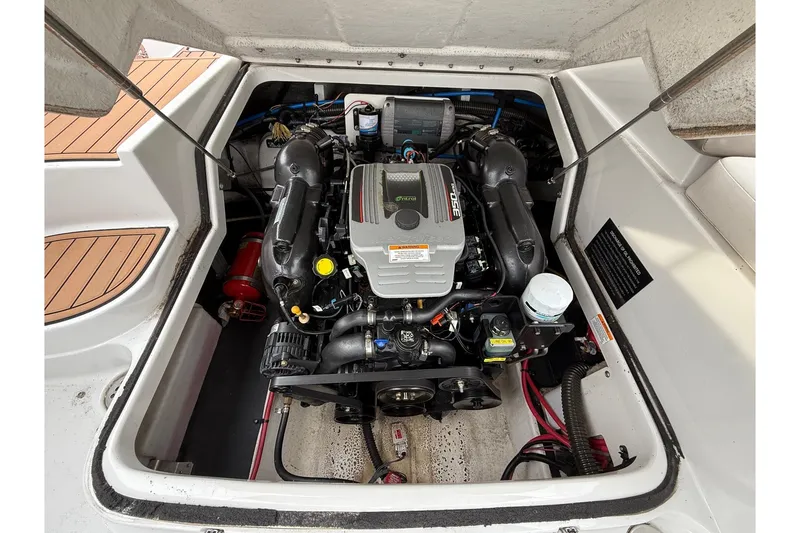 Slide: The Image of 2013 Crownline Eclipse E6 boat engine compartment, showcasing a clean and well-maintained motor. - 28