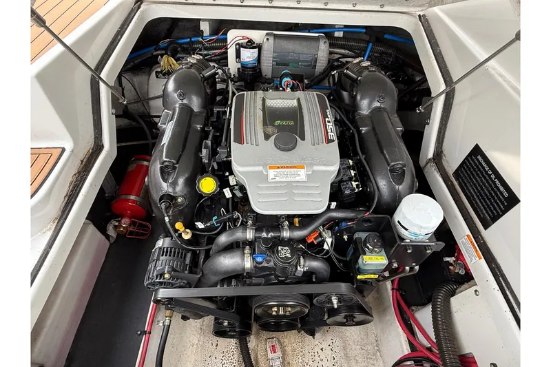 Slide: The Image of Engine compartment of a 2013 Crownline Eclipse E6 boat, featuring a powerful motor. - 29
