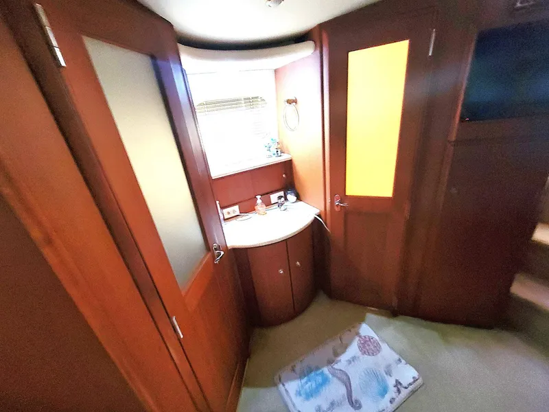 Slide: The Image of Interior of 2005 Silverton 43 Motor Yacht with wooden cabinetry and a small sink area. - 8