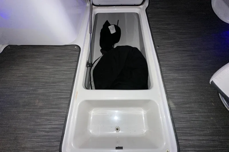 Slide: The Image of Storage compartment in 2017 Four Winns HD220 RS boat, featuring a black bag inside. - 13