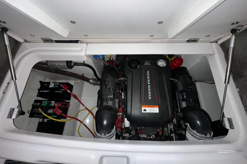 Slide: The Image of Engine compartment of 2017 Four Winns HD220 RS with Volvo Penta engine and battery setup. - 17