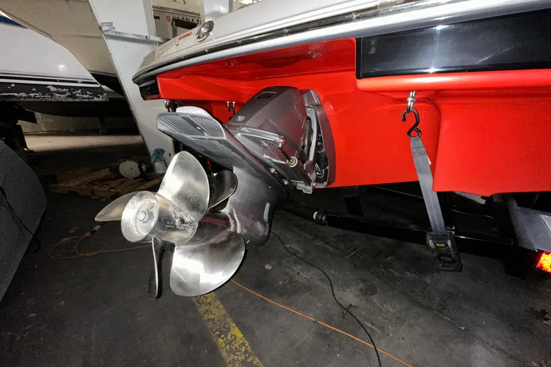Slide: The Image of 2017 Four Winns HD220 RS boat propeller and stern detail in a garage setting. - 18