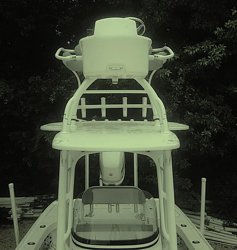 Slide: The Image of 2017 SeaVee 270Z boat with elevated helm station, surrounded by lush greenery. - 12