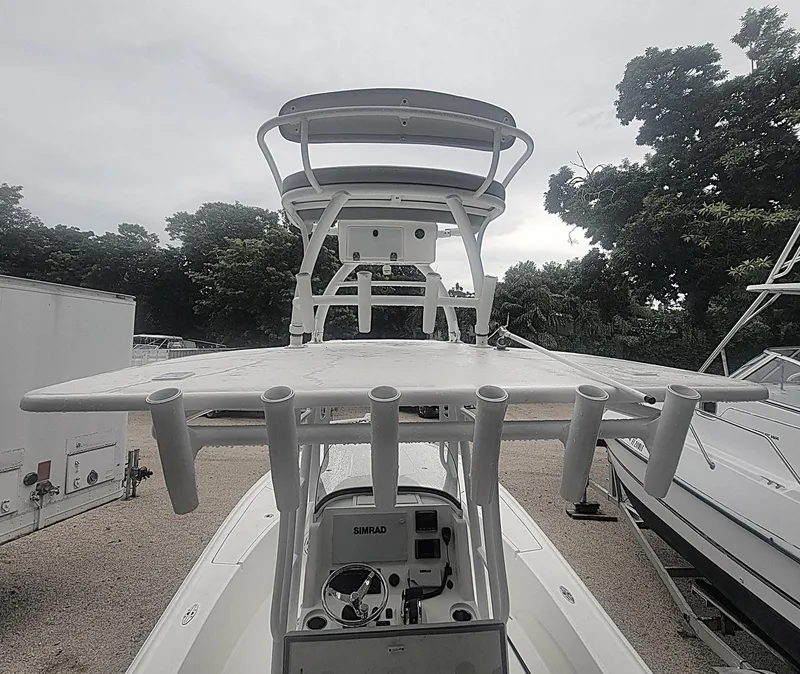 Slide: The Image of 2017 SeaVee 270Z boat with fishing rod holders and navigation equipment, docked outdoors. - 15
