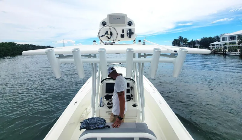 Slide: The Image of 2017 SeaVee 270Z boat on water, featuring helm and rod holders, with person onboard. - 16