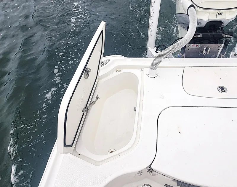 Slide: The Image of 2017 SeaVee 270Z boat with open storage compartment on deck, near water. - 18