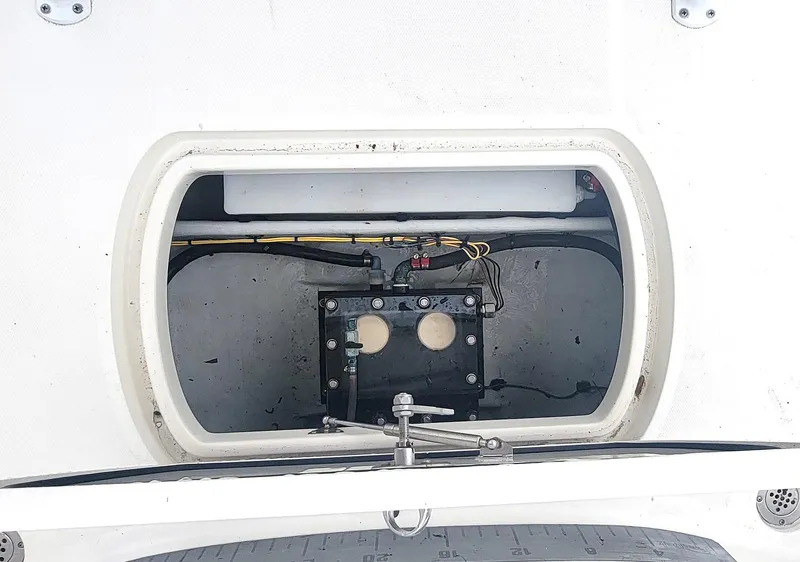 Slide: The Image of 2017 SeaVee 270Z boat storage compartment with wiring and components visible. - 23