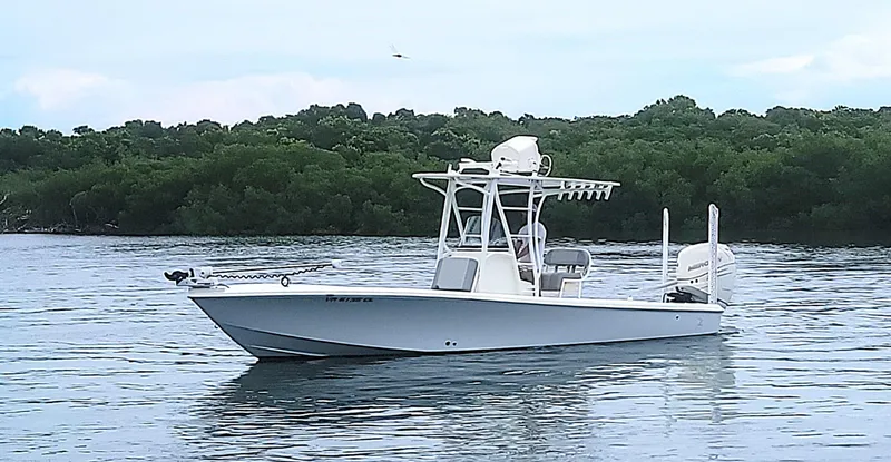 Slide: The Image of 2017 SeaVee 270Z boat on calm water with lush green background. - 4
