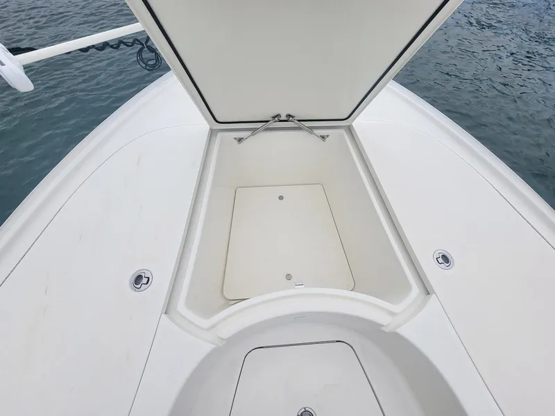 Slide: The Image of 2017 SeaVee 270Z boat with open storage compartment on deck, near water. - 8
