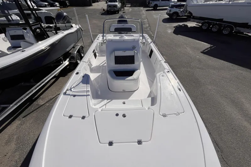 Slide: The Image of 2026 Tidewater 2110 Bay Max boat, sleek design, parked outdoors, showcasing spacious deck layout. - 10