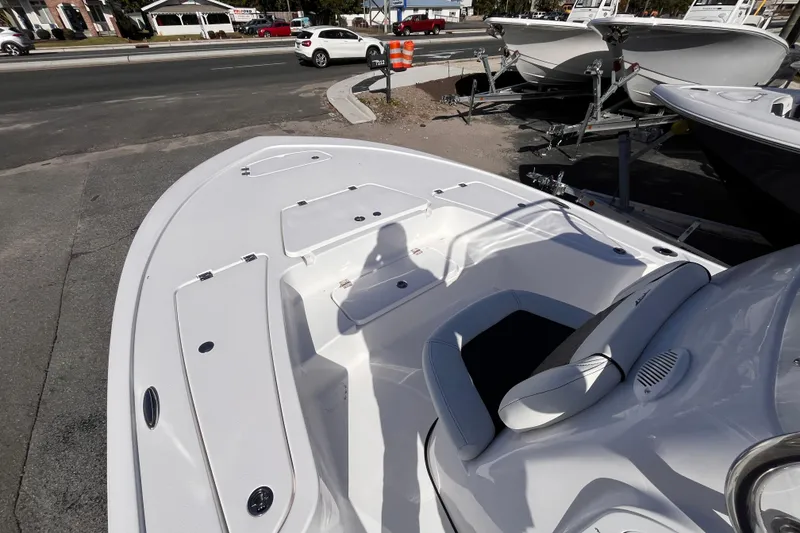 Slide: The Image of 2026 Tidewater 2110 Bay Max boat interior, showcasing seating and deck layout. - 11