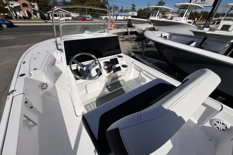 Slide: The Image of 2026 Tidewater 2110 Bay Max boat interior with steering console and seating. - 12