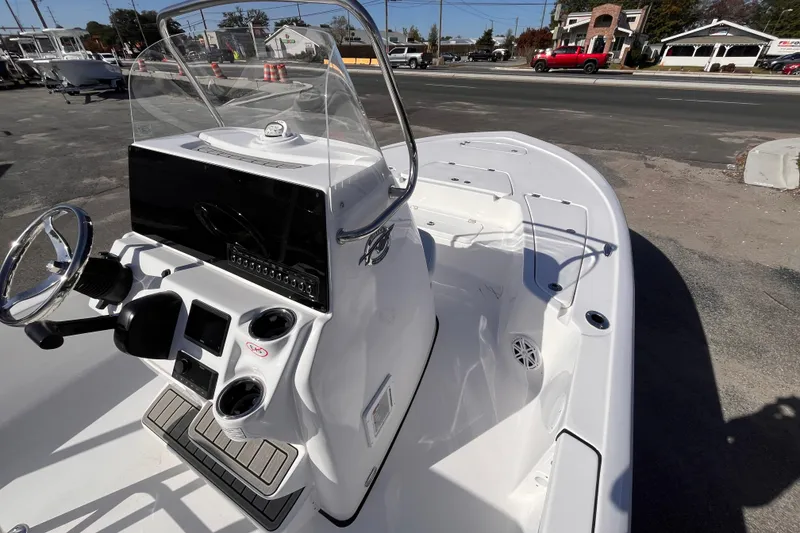 Slide: The Image of 2026 Tidewater 2110 Bay Max boat with sleek console and steering wheel, parked outdoors. - 8
