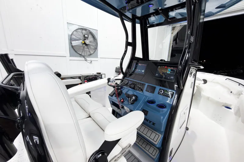 Slide: The Image of 2026 Tidewater 272 CC Adventure boat cockpit with modern controls and seating. - 17
