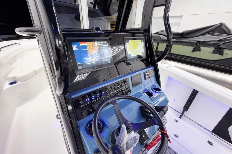 Slide: The Image of 2026 Tidewater 272 CC Adventure boat dashboard with navigation screens and controls. - 18