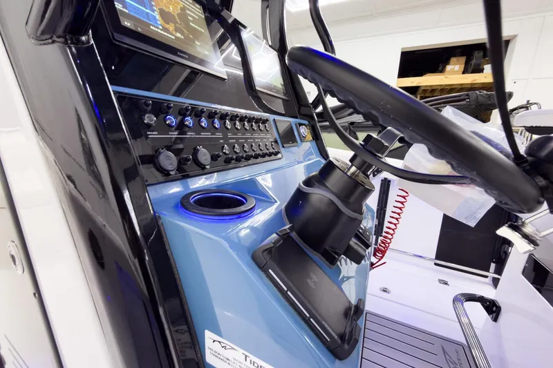 Slide: The Image of 2026 Tidewater 272 CC Adventure boat dashboard with advanced controls and navigation system. - 19