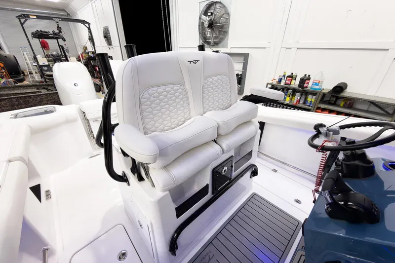 Slide: The Image of 2026 Tidewater 272 CC Adventure boat interior with plush seating and modern controls. - 24