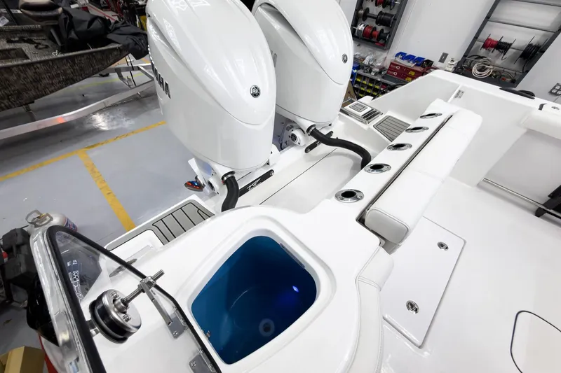 Slide: The Image of 2026 Tidewater 272 CC Adventure boat with dual engines and fishing rod holders. - 27