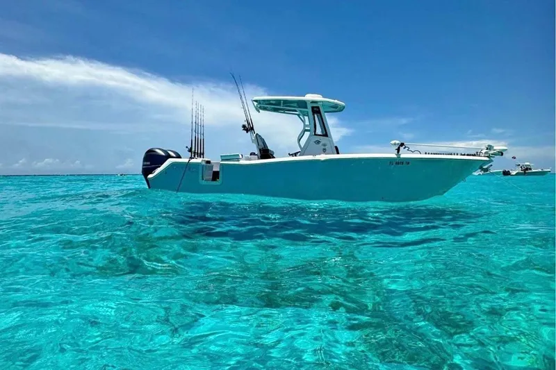 Slide: The Image of 2026 Tidewater 272 CC Adventure boat in a workshop, showcasing sleek design and modern features. - 3