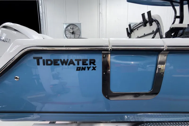 Slide: The Image of 2026 Tidewater 272 CC Adventure boat with Onyx trim, blue exterior detail. - 8