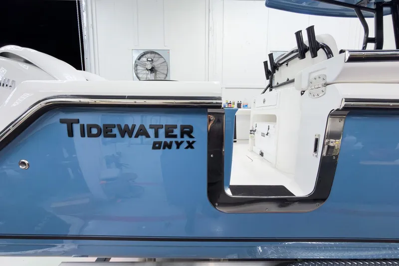 Slide: The Image of 2026 Tidewater 272 CC Adventure boat, blue exterior, Onyx model, sleek design. - 9