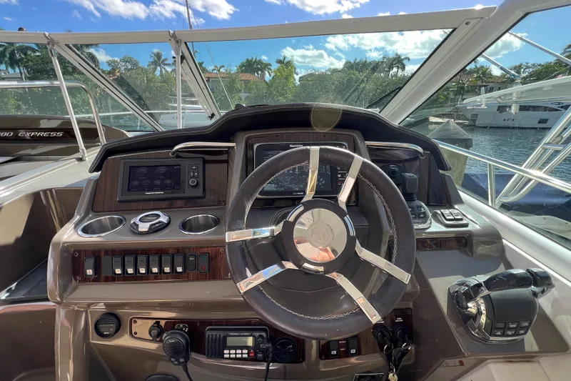 Slide: The Image of Cockpit view of 2013 Cruisers Yachts 380 Express with steering wheel and control panel. - 12