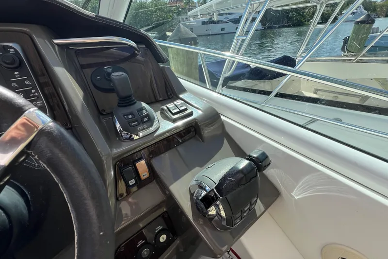 Slide: The Image of 2013 Cruisers Yachts 380 Express helm with controls and water view. - 14