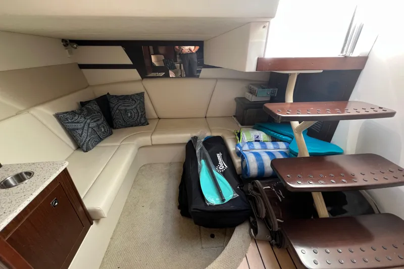 Slide: The Image of 2013 Cruisers Yachts 380 Express interior with seating, stairs, and nautical gear. - 19