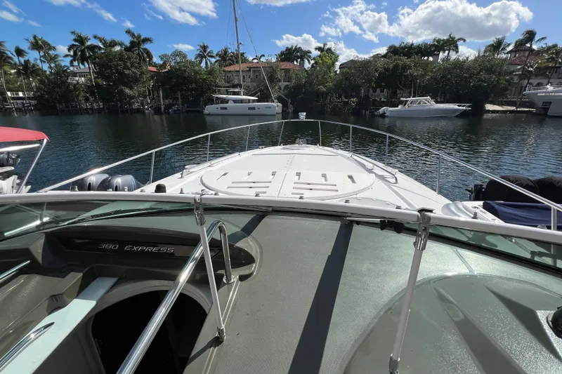 Slide: The Image of 2013 Cruisers Yachts 380 Express on a scenic waterway, surrounded by lush greenery. - 21