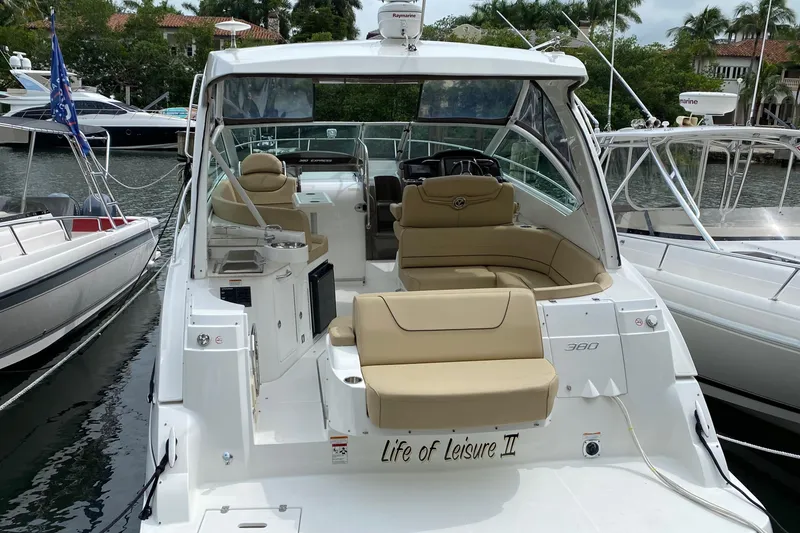 Slide: The Image of 2013 Cruisers Yachts 380 Express docked, featuring spacious seating and elegant design. - 3