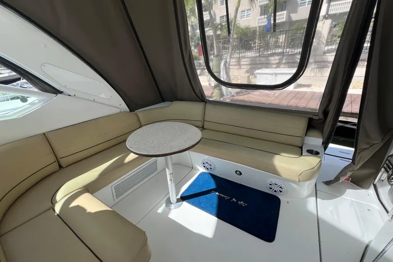 Slide: The Image of Interior of 2013 Cruisers Yachts 380 Express with beige seating and round table. - 4