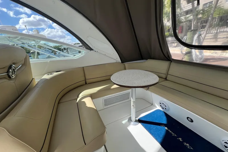 Slide: The Image of Interior of 2013 Cruisers Yachts 380 Express with beige seating and round table. - 5