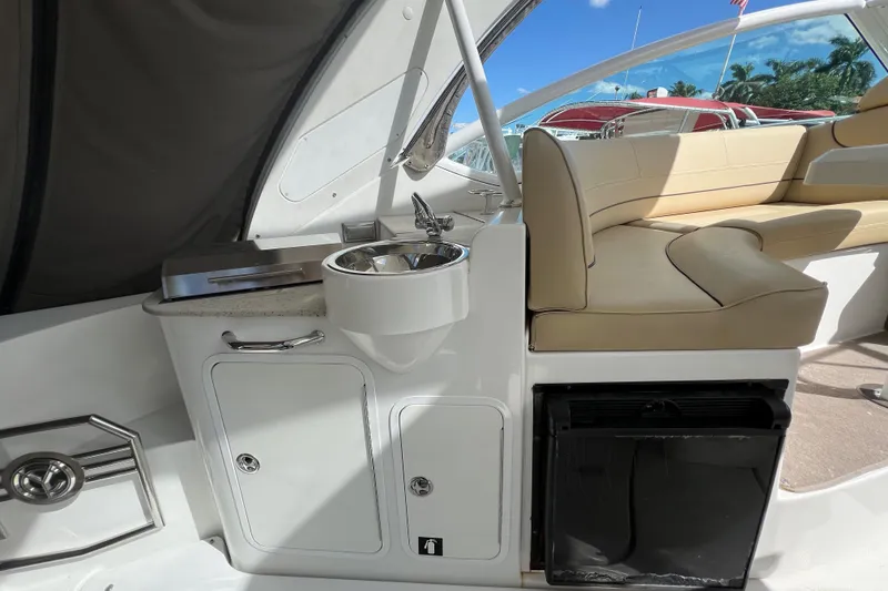 Slide: The Image of 2013 Cruisers Yachts 380 Express interior with sink, seating, and storage. - 8