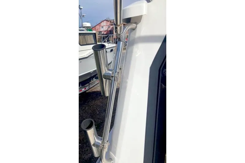 Slide: The Image of 2021 Ranger Tugs R-25 boat with stainless steel rod holders on deck. - 10
