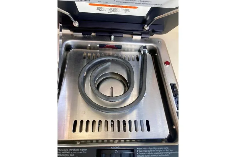 Slide: The Image of Stainless steel stove on 2021 Ranger Tugs R-25 boat, featuring a coiled heating element. - 21