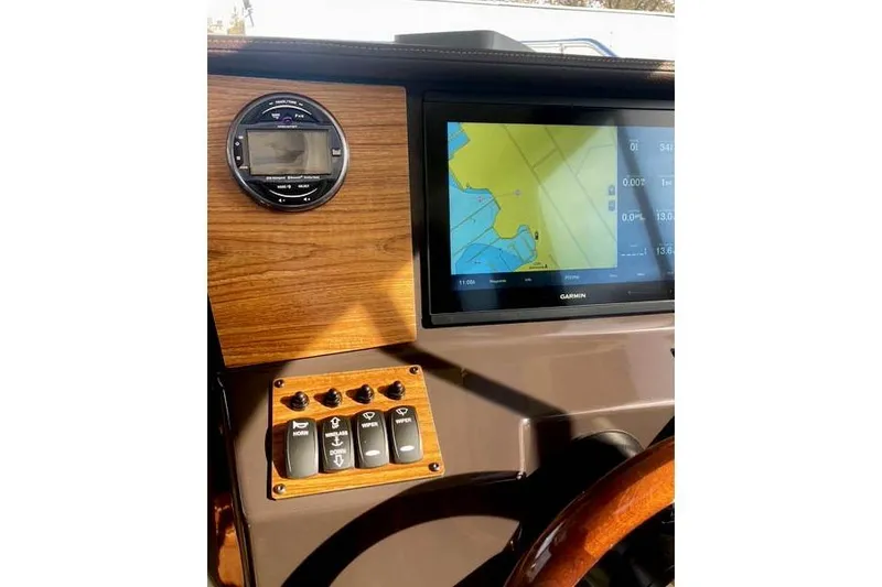 Slide: The Image of 2021 Ranger Tugs R-25 dashboard with Garmin navigation and control panel. - 25