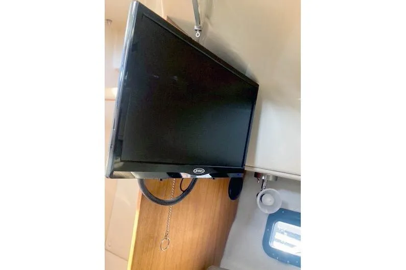 Slide: The Image of Interior of 2021 Ranger Tugs R-25 with mounted TV and window. - 30