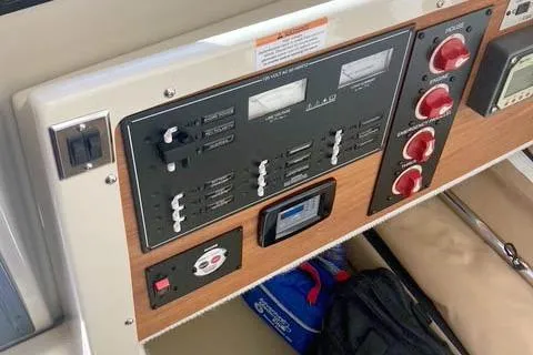 Slide: The Image of Control panel of 2021 Ranger Tugs R-25 boat with switches and gauges. - 32